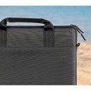 Dell EcoLoop Black Sleeve Case for 11-14 Inch Notebooks in a beach setting, emphasizing its stylish design and portable convenience.