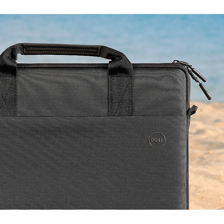 Dell EcoLoop Black Sleeve Case for 11-14 Inch Notebooks in a beach setting, emphasizing its stylish design and portable convenience.