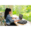 A person using a Dell EcoLoop Pro Sleeve for 15-16" laptops while working on a laptop at a wooden table surrounded by greenery. This stylish, scratch-resistant sleeve from Dell offers essential protection for your tech.