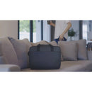 Dell EcoLoop Pro 16" Notebook Carrying Case elegantly placed on a chic sofa, showcasing its stylish black design and ideal for modern professionals.