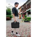 A man confidently walking with the Dell EcoLoop Pro 16" Notebook Carrying Case, demonstrating its functionality and sleek design in a vibrant street atmosphere.