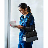 Health professional using Dell EcoLoop Rugged Case for 13.3" Latitude 7350, emphasizing mobility and functionality in a clinical setting.
