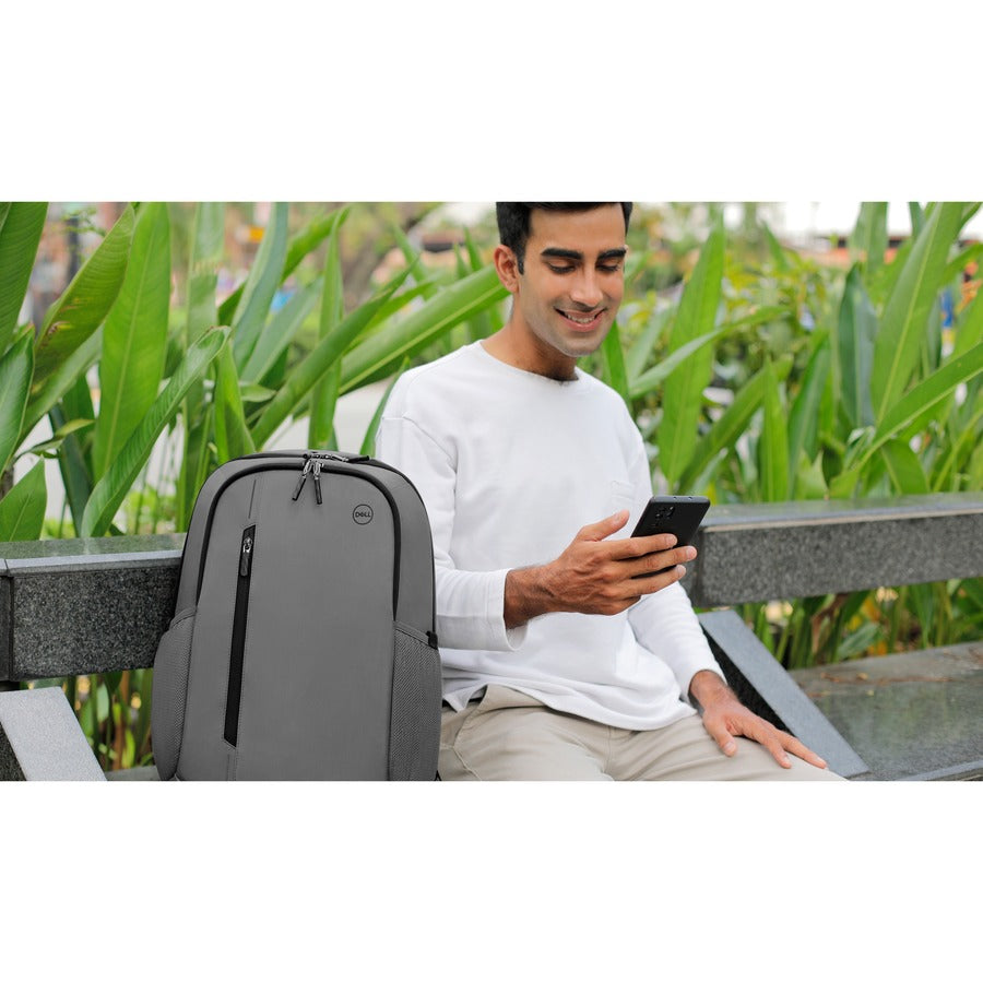 Man enjoying his time outdoors with the Dell EcoLoop Urban CP4523G 15" Weatherproof Backpack beside him, blending style and functionality.