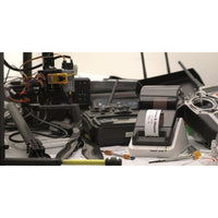 Seiko 203 DPI Smart Label Printer situated on a cluttered workspace, demonstrating its practical use in busy environments for custom label creation.