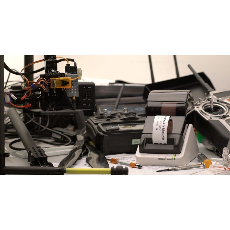 Dynamic setup with the Seiko 203 DPI Smart Label Printer amidst technical equipment, highlighting innovation in label printing for professional use.