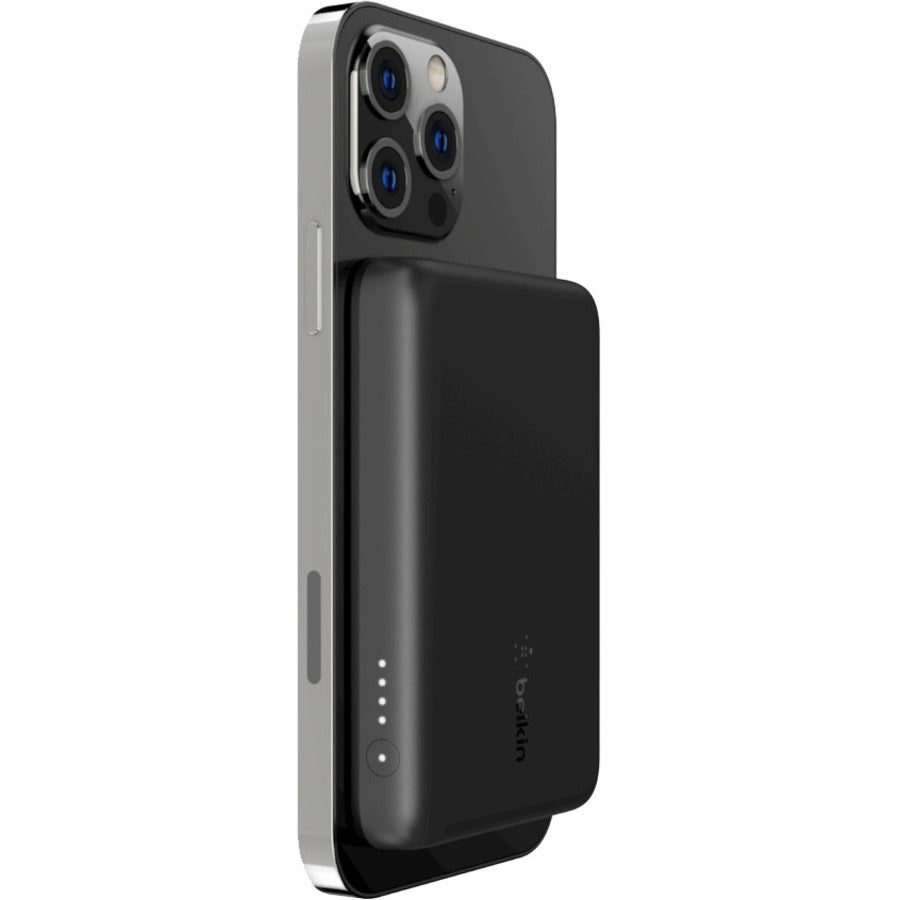 Belkin BoostCharge MagSafe Wireless Power Bank 2500 mAh securely attached to an iPhone, demonstrating its effective charging capabilities while maintaining style and functionality.