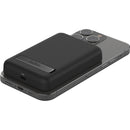 Belkin MagSafe Power Bank 5K wirelessly charging an iPhone, demonstrating seamless magnetic attachment.