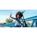 A joyful user takes a selfie with the Belkin BoostCharge Magnetic Power Bank 5000mAh with Stand for iPhone nearby on a scooter, exemplifying the perfect companion for those who live an active lifestyle.