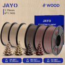 All spools of JAYO Wood PLA 3D Filament in various wood-inspired shades with a decorative tree model, showcasing the filament's versatility for creating stunning crafts.